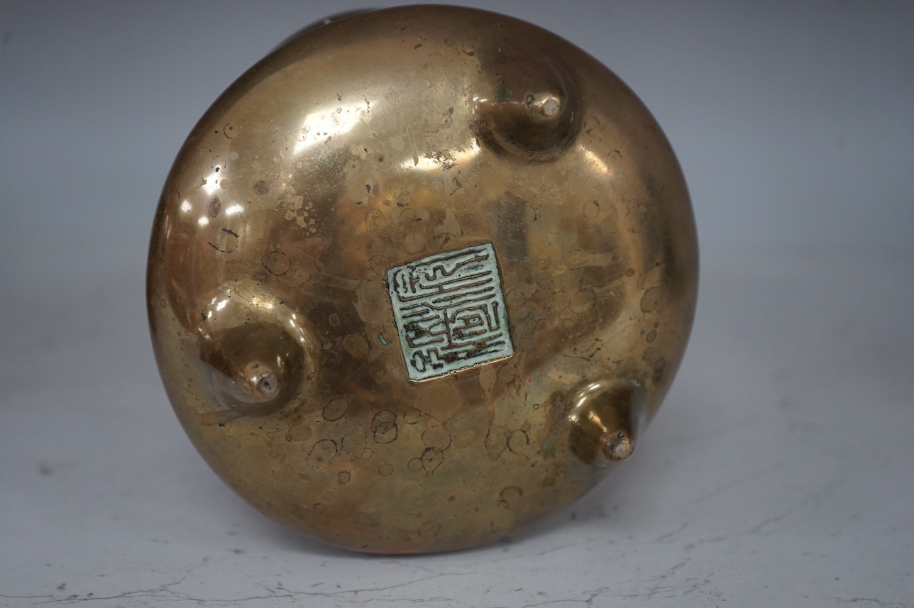 A Chinese bronze tripod censer, archaic Xuande seal mark, 19th century, 11cm. Condition - good